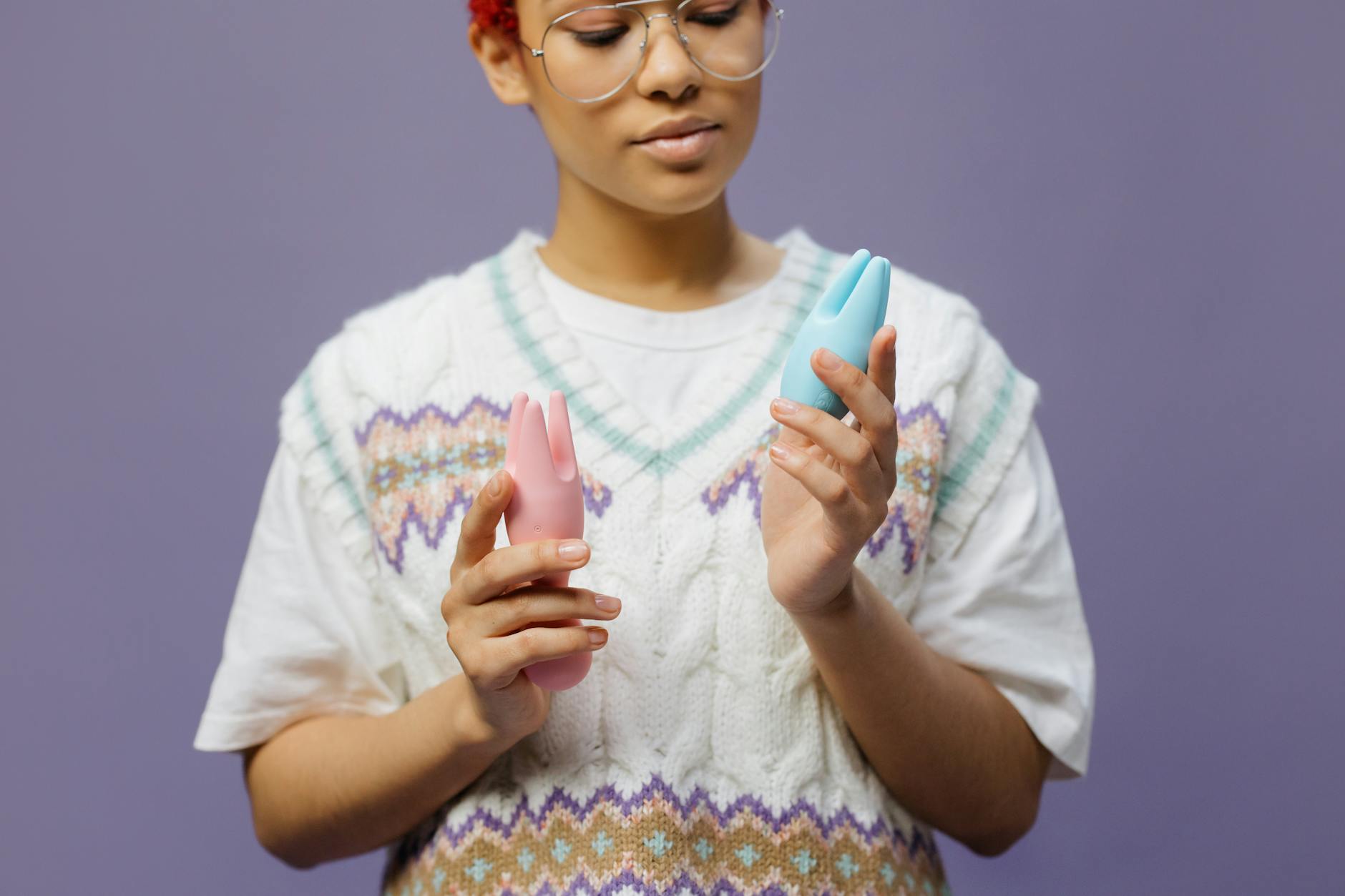 A teal lemon vibrator resting on smooth white silk, showcasing the device used for pelvic floor wellness.