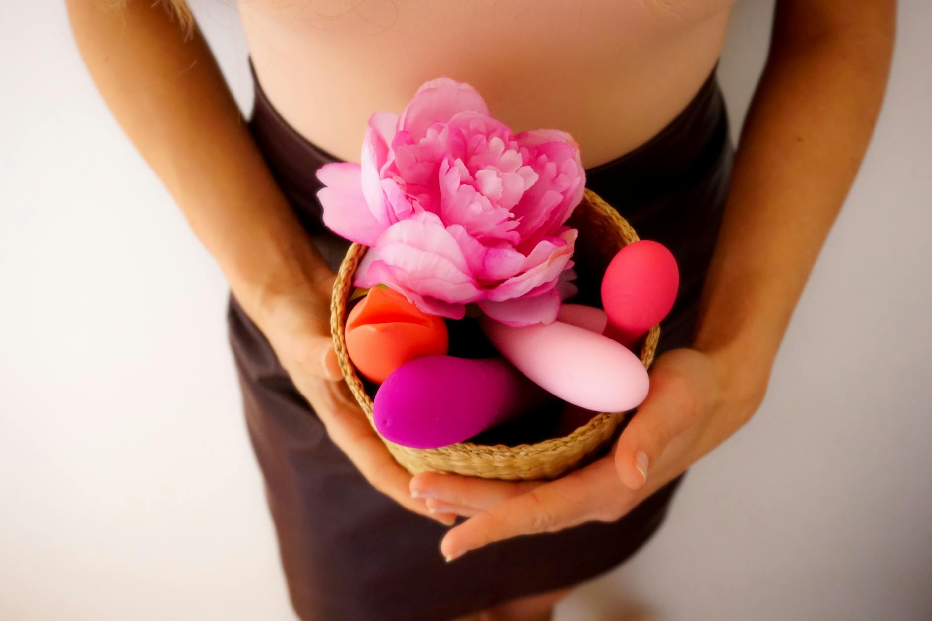 Vibrant arrangement of colorful sex toys on a bright yellow surface, representing pleasure and design diversity