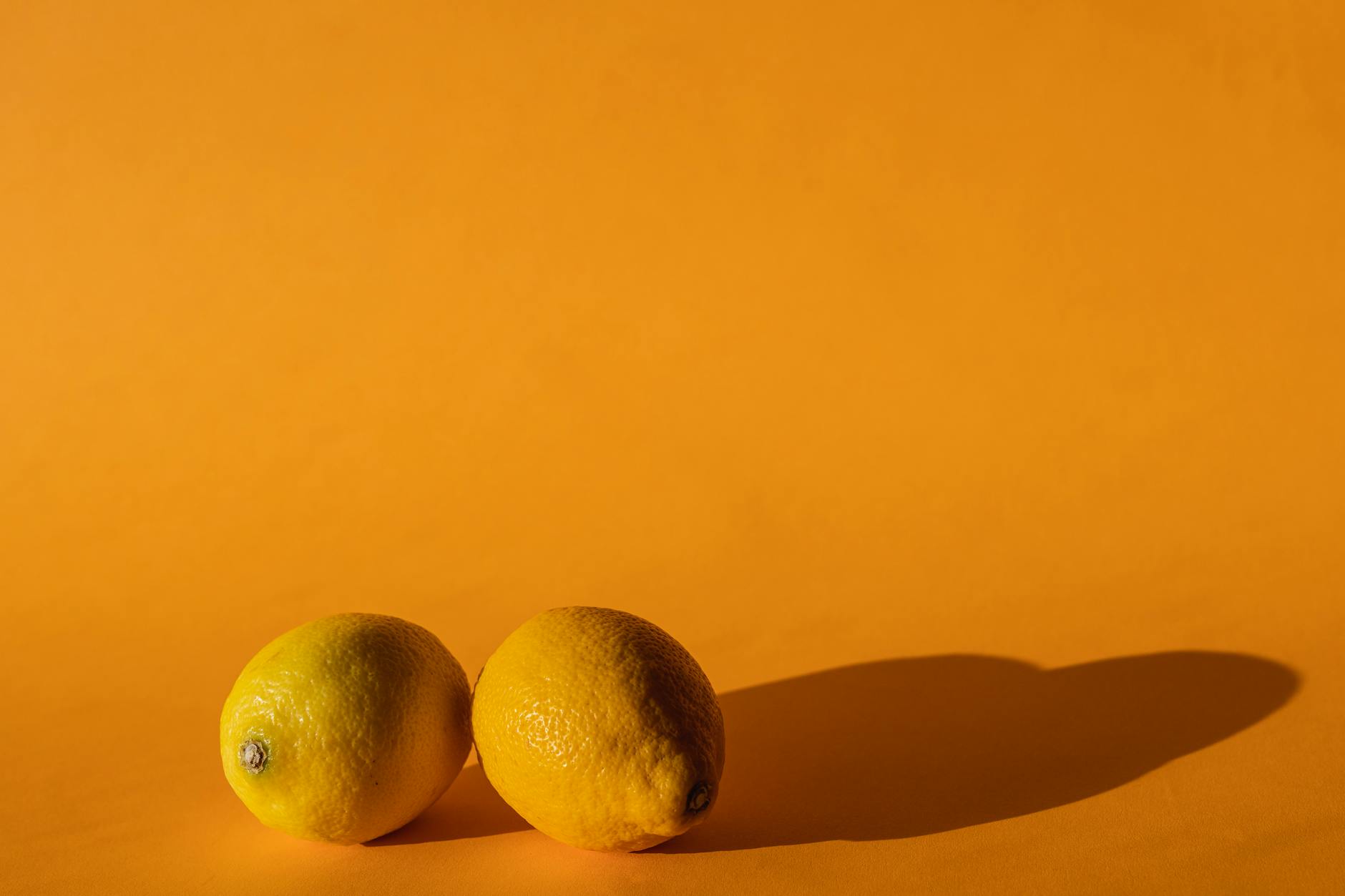 Bright yellow lemons on a soft pastel background symbolizing fresh starts and renewal