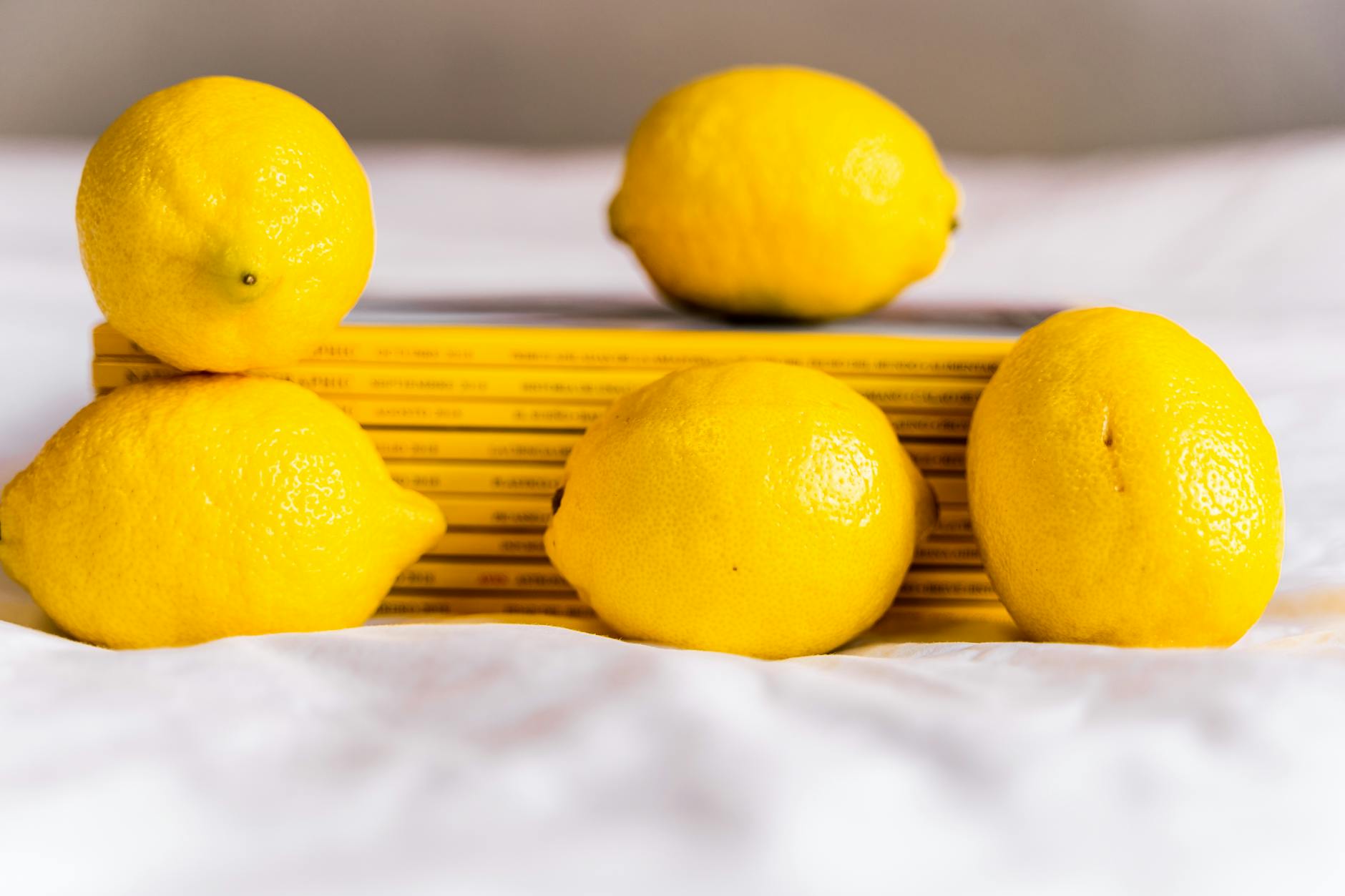 Fresh bright ripe lemons arranged on pastel background symbolizing sensitivity and freshness
